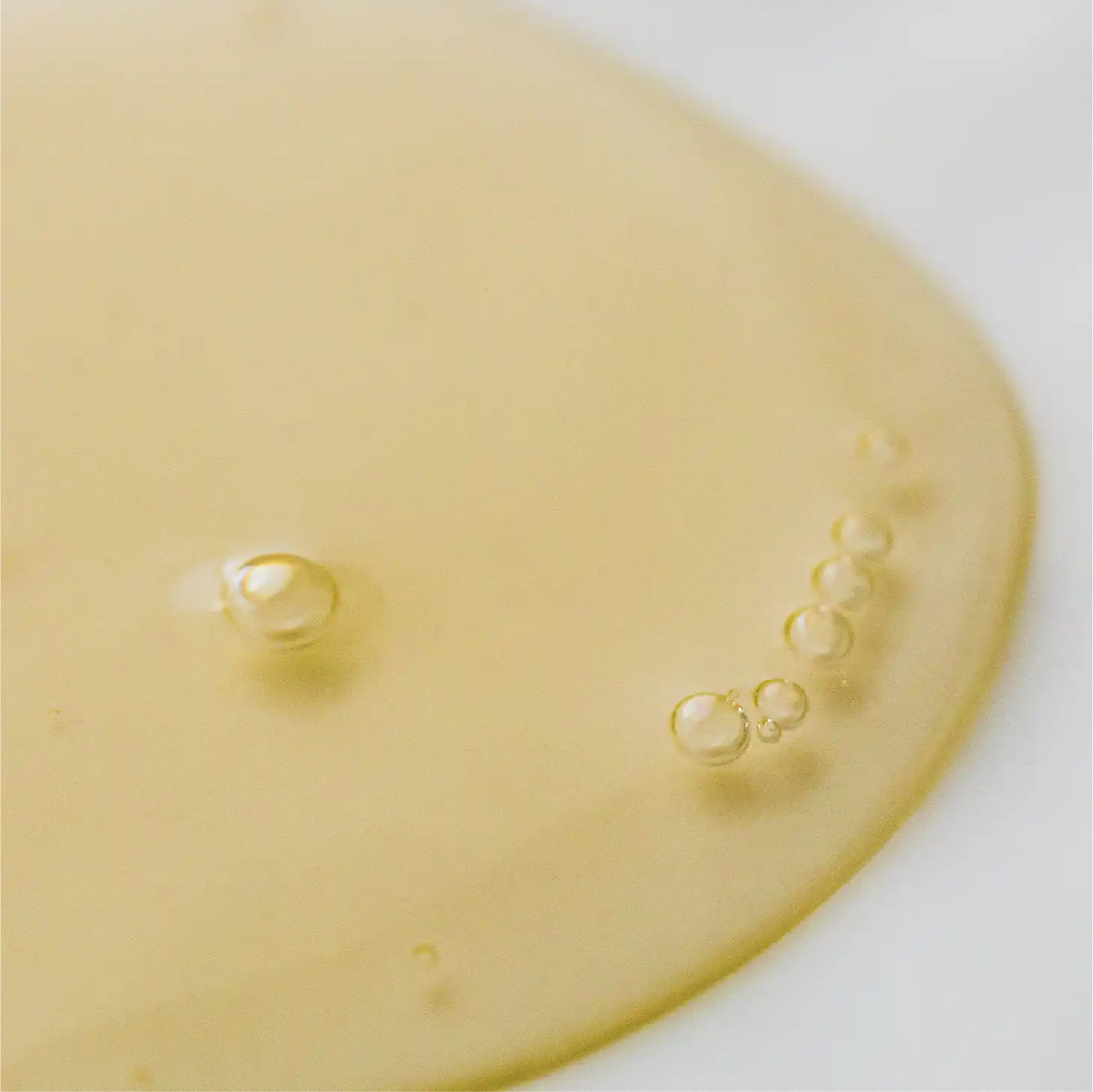 A close up of a piece of cheese with water droplets.